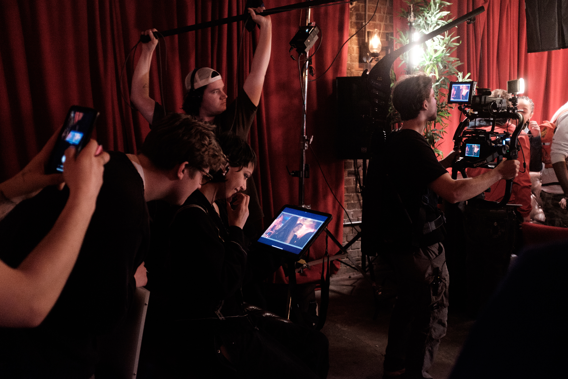 Behind the scenes on set — crew filming a performance